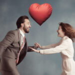 man_jumping_over_women_with_his_heart_in_his_hand